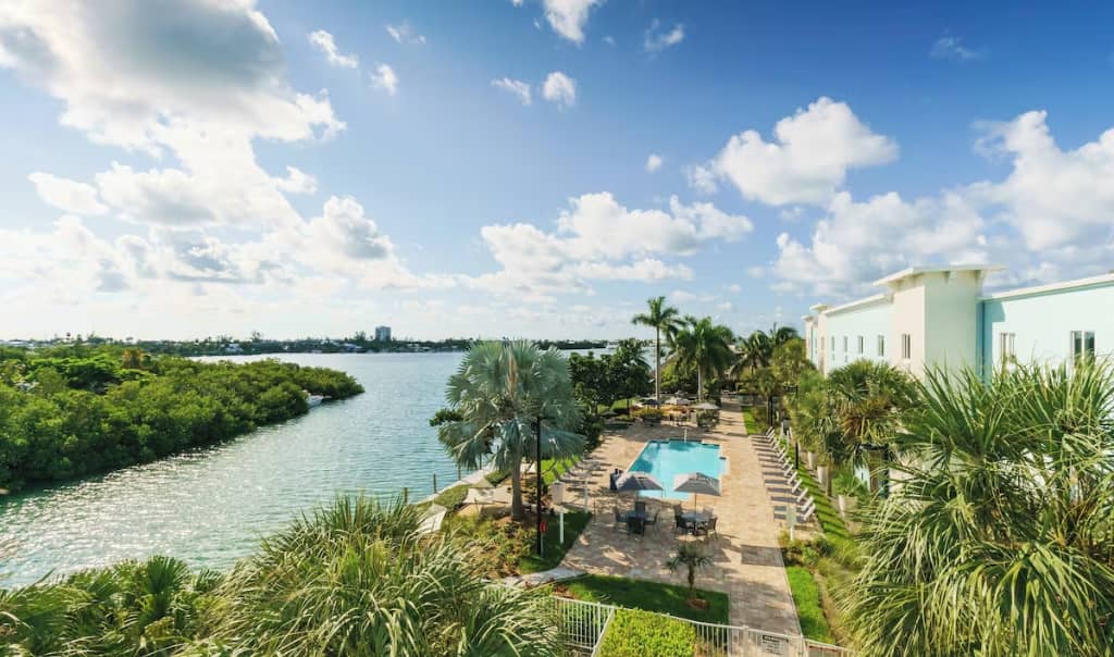 aerial shot of the fairfield inn in marathon florida, large building along the water with a pool and palm trees